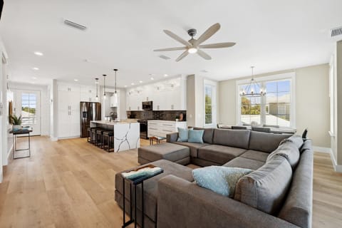 Open-concept living room with sectional seating, electric fireplace, and Smart TV on the 2nd floor