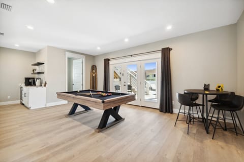 Entertainment-ready game room with pool table and smart TV.