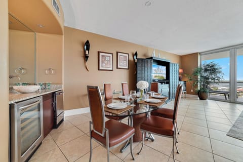 Gather around the elegant dining table, ready for memorable meals and conversations in this beautifully appointed bayfront condo.