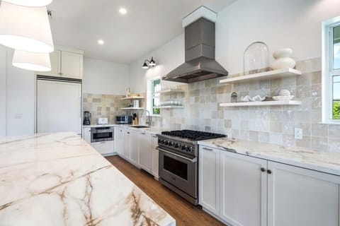 Gourmet kitchen equip with blender, Keurig coffee machine, crockpot, lots of cookware, and enough dishes and dining utensils for everyone.