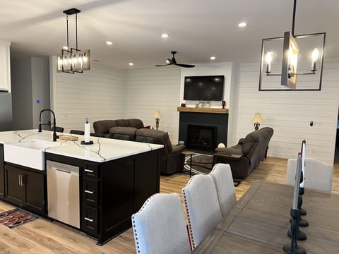 Shows living room, kitchen and dining all in one.