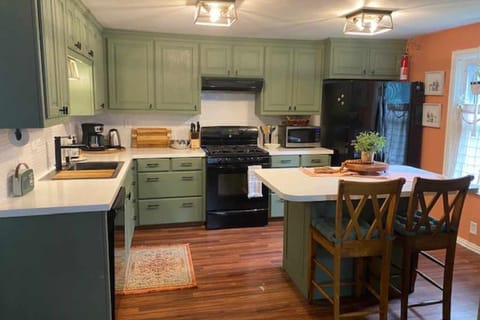 Fully equipped kitchen with dishwasher, gas stove, microwave and fridge. 