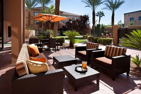 Sip something cool on the shaded patio among palms.