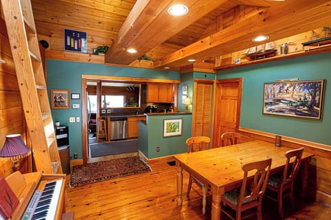 Dining room in main house. High ceilings, electric piano & loft bedroom