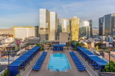 Dive into a picture-perfect rooftop pool framed by towers.