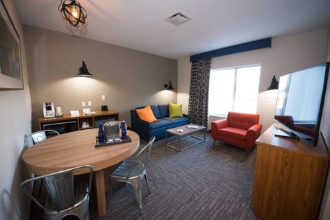Settle into a bright suite living room with plenty of seating.