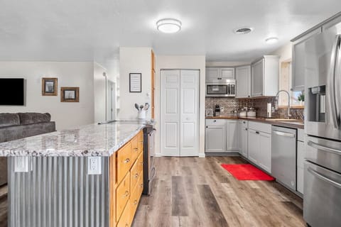 Prepare delicious meals in our fully equipped kitchen, featuring stainless steel appliances and ample counter space.