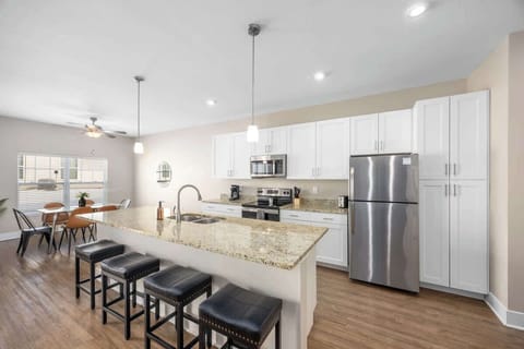 Modern kitchen with sit-up bar for dining, coffee, or gathering with friends.
