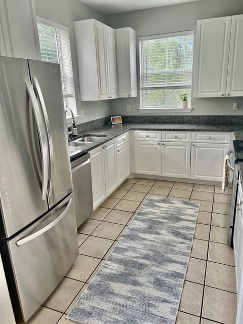 Spacious kitchen with stainless steel appliances and lots of natural lighting