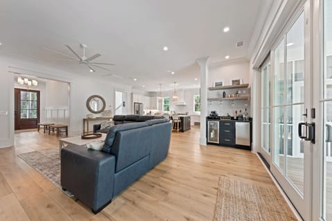 A bar in the great room with beverage center and ice maker