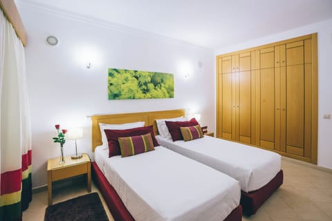 Drift off comfortably in twin beds with soft bedside lighting.