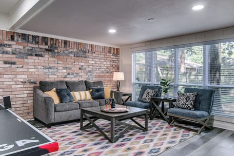 sunroom with ping pong table and pull out couch