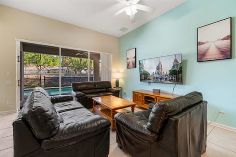 Comfortable living room with updated paint tones and natural light throughout.