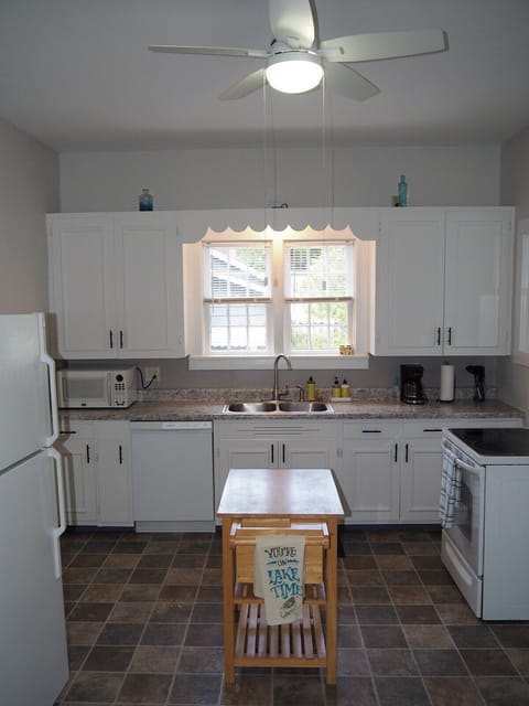 KITCHEN:  The home has a HUGE kitchen that is complete with all modern appliances, including a dishwasher.  A good supply of cooking and dining utensils are included as well.