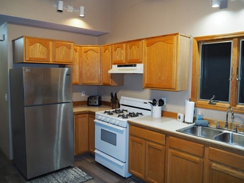 KITCHEN:  Full kitchen with all modern appliances including a microwave, toaster, coffee maker, and dishwasher.  Also includes lots of cabinet space and a good supply of cooking and dining utensils.