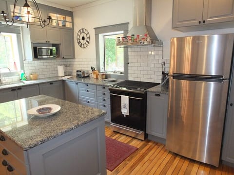 KITCHEN:  Another angle, highlighting the electric range and the new stainless steel refrigerator.