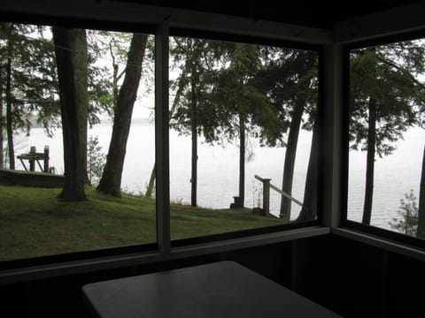 FRONT PORCH:  The cabin has a lovely screened-in porch with a picnic table and a great view of Little Platte Lake