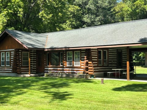 EXTERIOR:  Another view of the front of the cabin in summer.