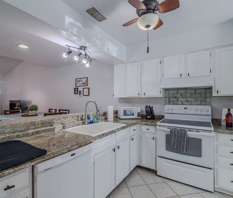 7. Kitchen overviewing the dining room and living room. Fully stocked with pots, pans, blender, toas (1)
