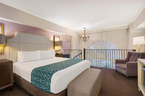 Unwind in a plush king bed beneath soft, calming light.