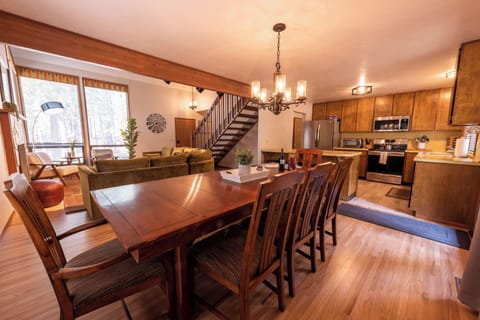 Large dining room table seats 8 plus 3 stools at the counter.