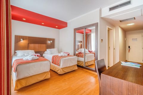 Unwind in a bright twin bedroom with crisp linens.