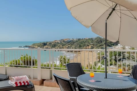 Unwind with sunset drinks as the coastline sparkles below.