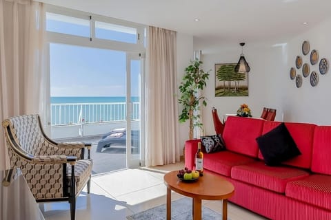 Relax by the window with endless blue sea views.