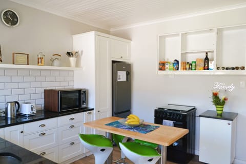 There is a large fridge-freezer and a gas hob oven.