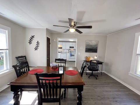 Dining room with table and six padded chairs. Leaf for table available in closet