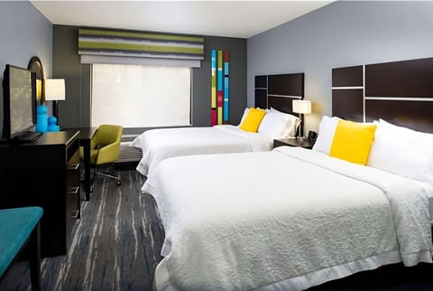 Unwind in bright double-queen comfort with bold modern style.