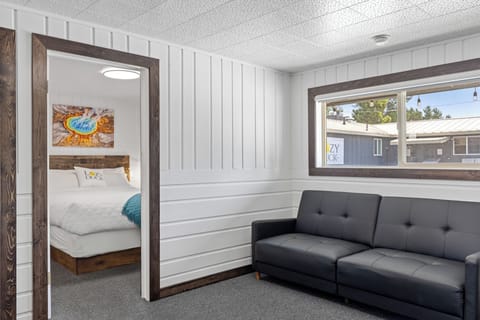 Living room with pull out sofa bed and entrance to guest room #1