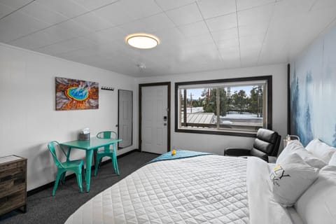 King size bed with reclining chair, table for two, full length mirror and giant window with privacy blinds