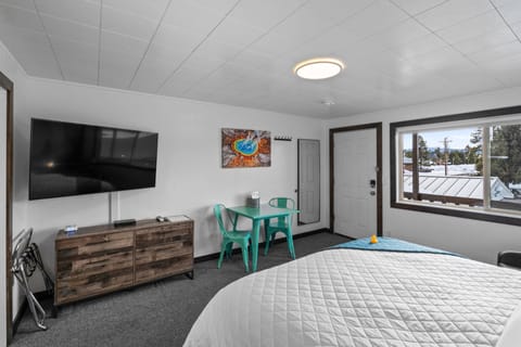 King size bed, table for two, large dresser and flat screen TV