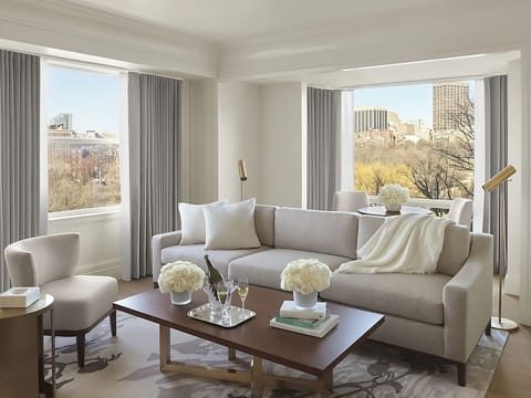 Lounge with champagne as sunlight pours through picture windows.