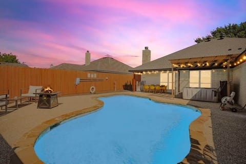 This backyard is a private retreat for you and your guests, featuring a custom swimming pool, fire pit, patio, and jacuzzi – what more could one ask for?!