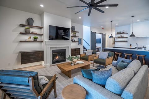 Main floor living room with sofa + chair seating, cable TV, and fireplace