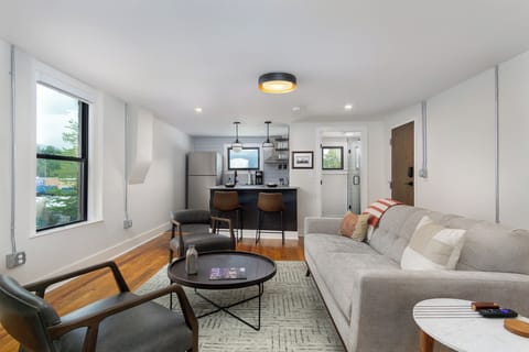 Open-concept kitchen and living room with Smart TV for streaming.