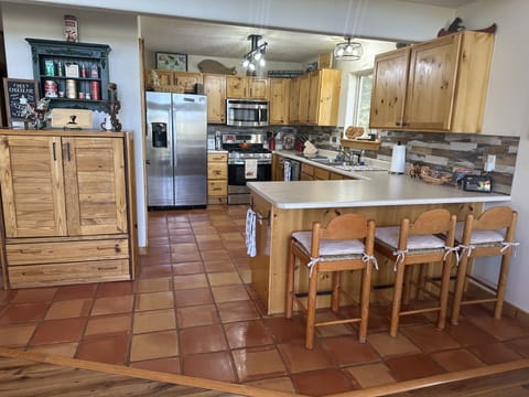 The kitchen bar seats 3.