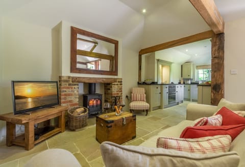 Ground floor: Open plan living area with wood burner and original oak beams