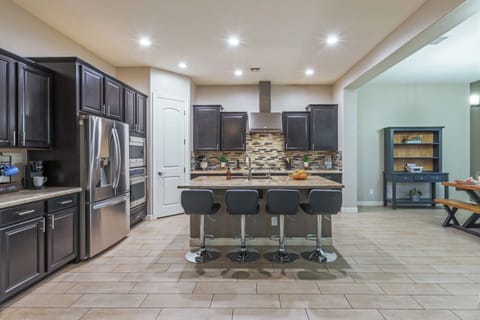 Open concept kitchen has generous counter space and island for prepping and serving your favorite cuisine.