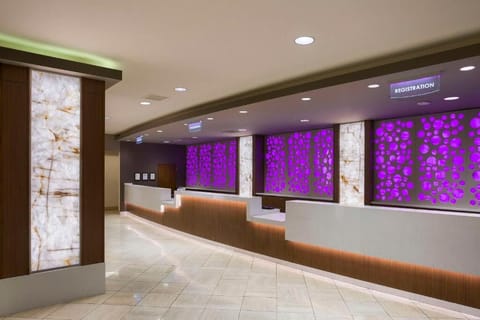 Move seamlessly through check-in at the expansive, illuminated registration desk.