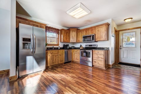 A full kitchen features granite countertops and an electric range.