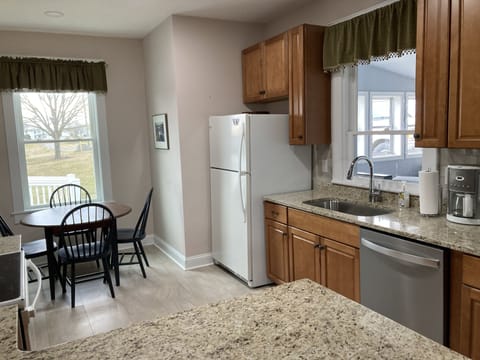 Remodeled kitchen stocked with utensils, basic spices, sugar, tea and coffee.