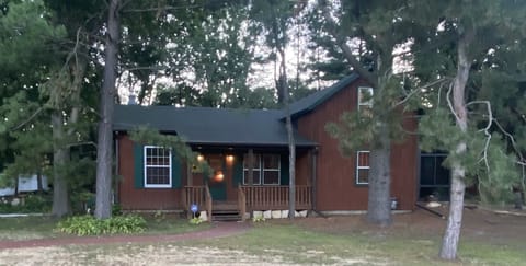 Front of home, deck with chairs to sit and relax.