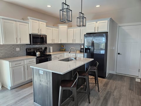 Kitchen island has seating for 3