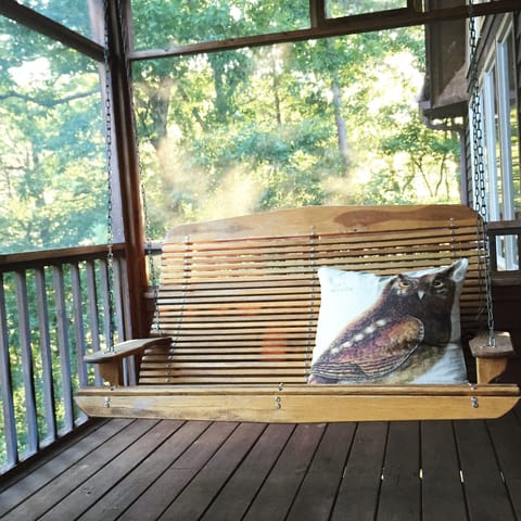 Swing away listening to the sounds of the creek on the screened porch