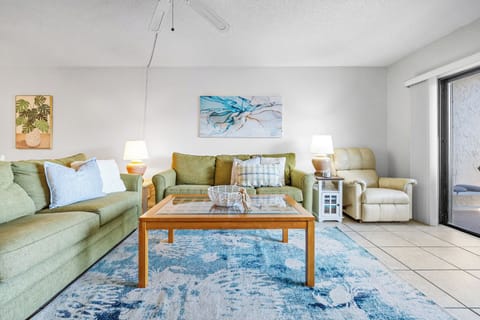Sink into the cozy couch, feel the ocean breeze through the balcony doors.