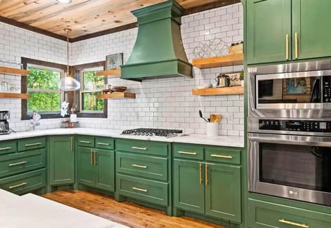 Cook in comfort with our expansive counters and stylish green cabinetry