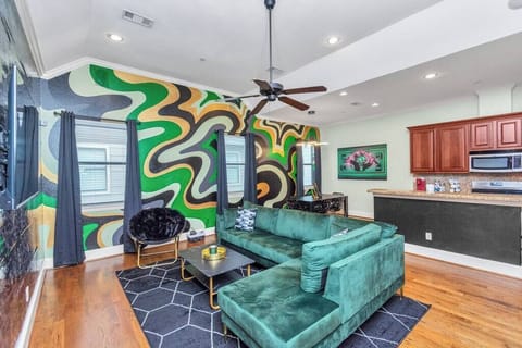 The family room features a designer velvet sectional sofa and cozy accent chair. 